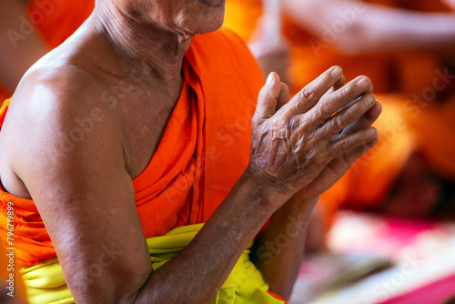 Thai monks prayer hands on their chests to pray in religious ceremonies. photo