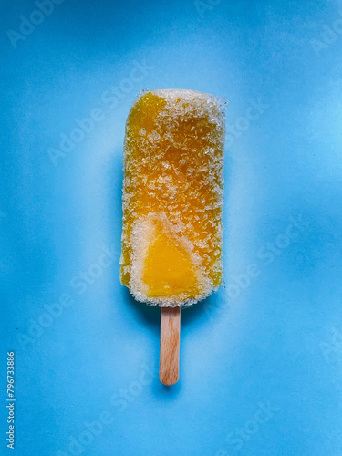 yellow frozen ice cream on a stick © Monika