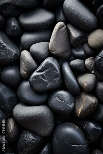 b'Close-up of a pile of smooth, round, black stones' photo