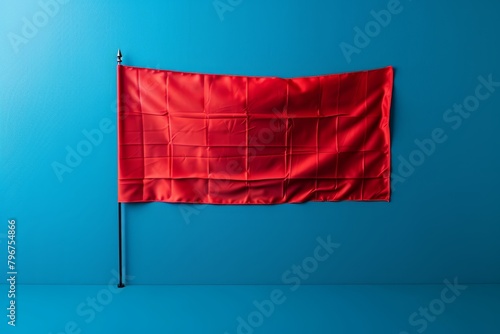 A red flag hanging on a blue background. photo
