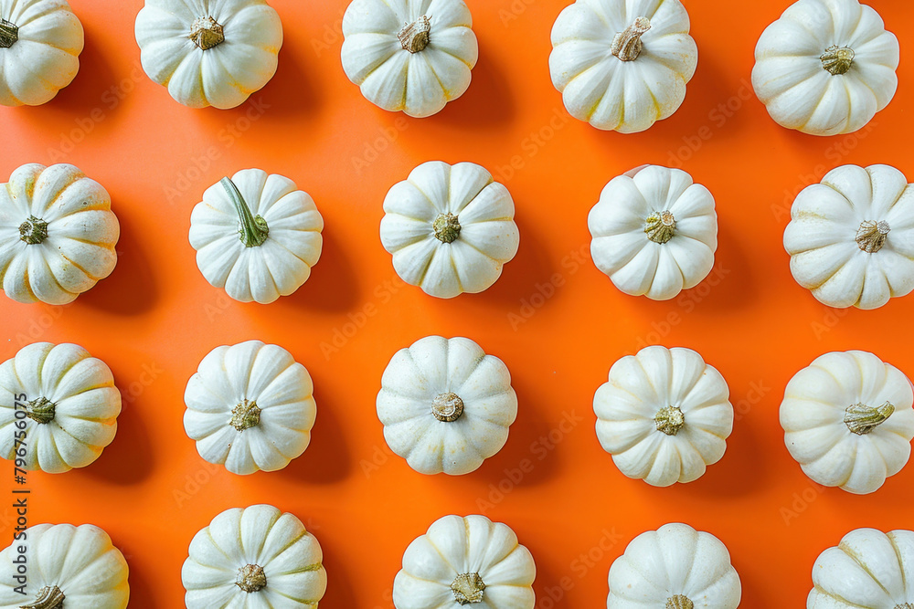 Naklejka premium Pattern of White Pumpkins on Orange Background, Top View for Fall and Thanksgiving Season Decorations