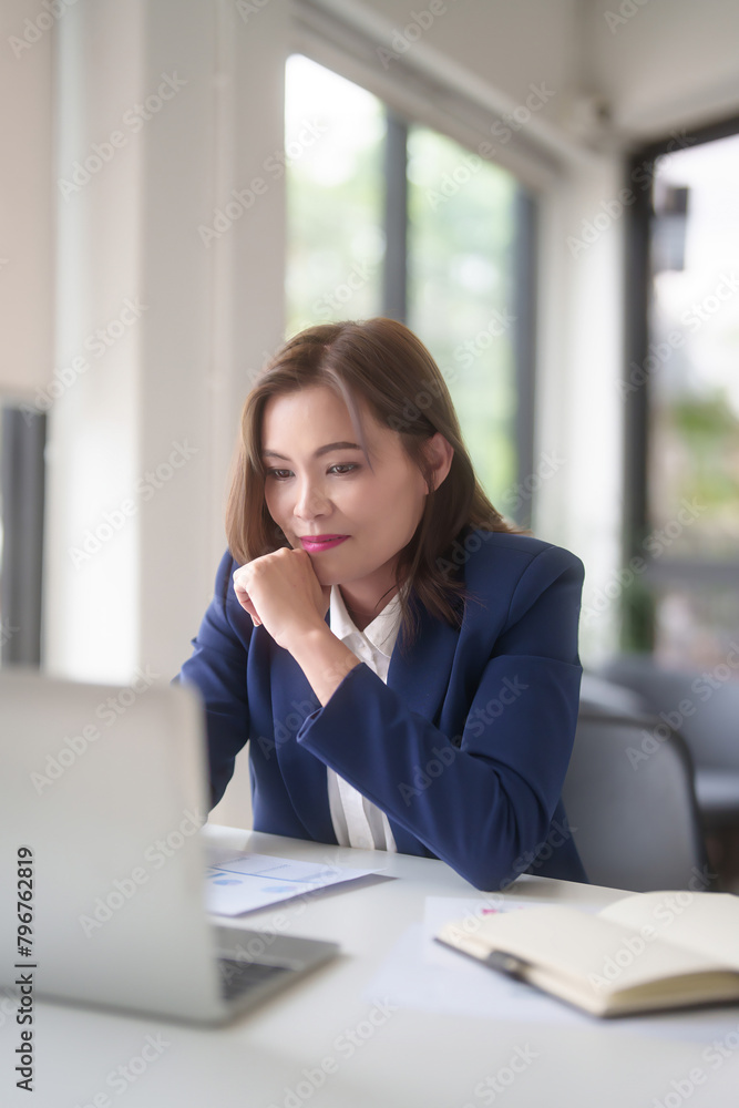 Asian businesswomen typing on keyboard laptop to researching business data and thinking about strategy of new business while analyze investment and market stock of new startup in outside office Asian businesswomen typing on keyboard laptop to researching business data and thinking about strategy of new business while analyze investment and market stock of new startup in outside office