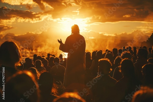 Rear shot of Jesus at The Sermon on the Mount, the setting sun creating a silhouette as He speaks to an absorbed crowd, photo