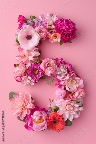 Overhead Vibrant Floral Arrangement Number Five. Overhead view of vibrant floral arrangement number 5 shape on pink background, ideal for romantic events.