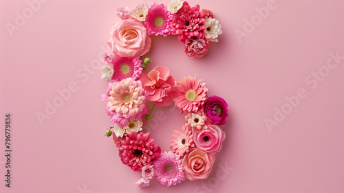 Top View Floral Number Six Decoration. Top view of number six made with beautiful flowers on a pink background.