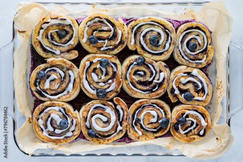 Above view of a baking dish of freshly baked blueberry cinnamon rolls.