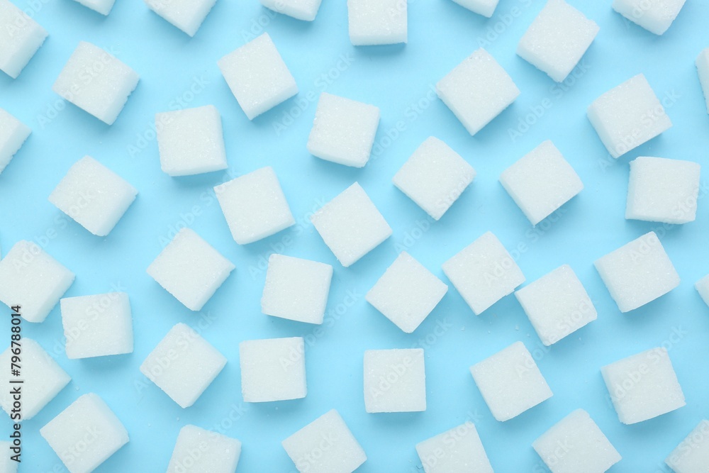 White sugar cubes on light blue background, top view White sugar cubes on light blue background, top view