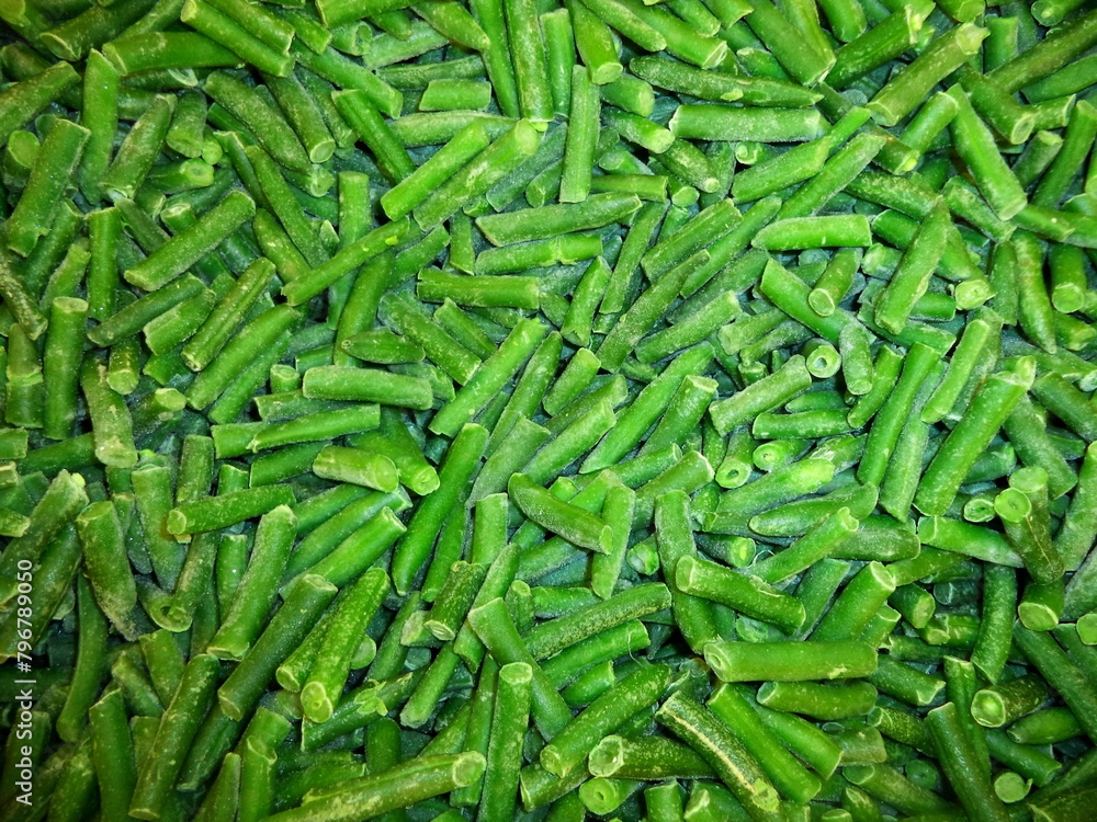 Сlose-up green beans in market frozen fresh vegetables food background. Healthy vegetarian beans concepts, text space. Frozen beans green vegetable background. Green frozen cut french bean texture Сlose-up green beans in market frozen fresh vegetables food background. Healthy vegetarian beans concepts, text space. Frozen beans green vegetable background. Green frozen cut french bean texture