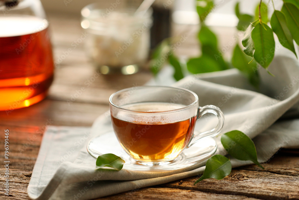 Tasty tea in cup on wooden table, closeup Tasty tea in cup on wooden table, closeup