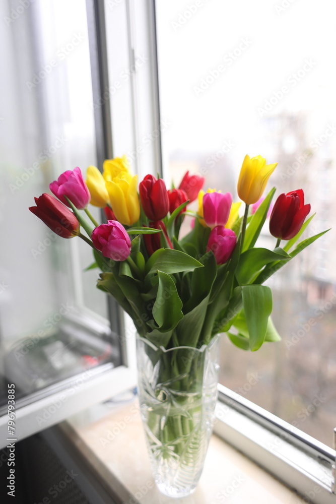 A bouquet of tulips in a vase on the window. A bouquet of tulips in a vase on the window.