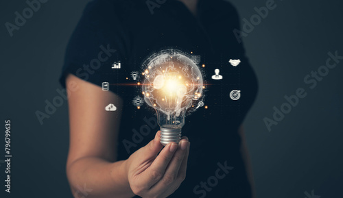 Light bulb in hand. The digital world. Links to doing business online. Searching for ideas for starting a business. Finding information and defining customer groups with internet technology.