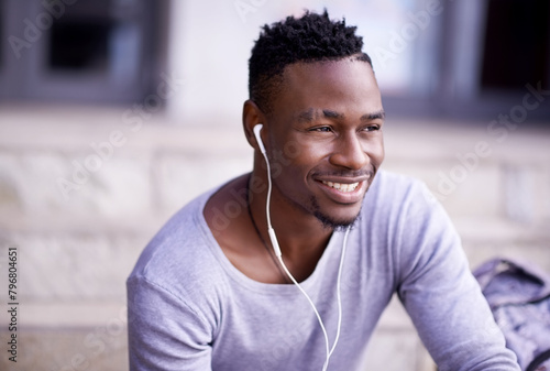 Outdoor, earphones and black man in campus, smile and listening to audio, radio and music in morning. Academy, student and university for person, education and knowledge in Atlanta, city and relax photo