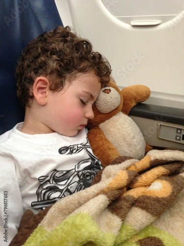 boy sleeping on plane