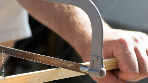Hand saw with hardened teeth isolated. saw in hand, hacksaw at work. cut the wood plank. close-up. repair concept, construction material cutting, working tool.
