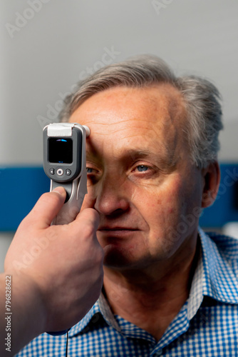 close up in an ophthalmology clinic checking the pressure of the eyeball of an elderly patient