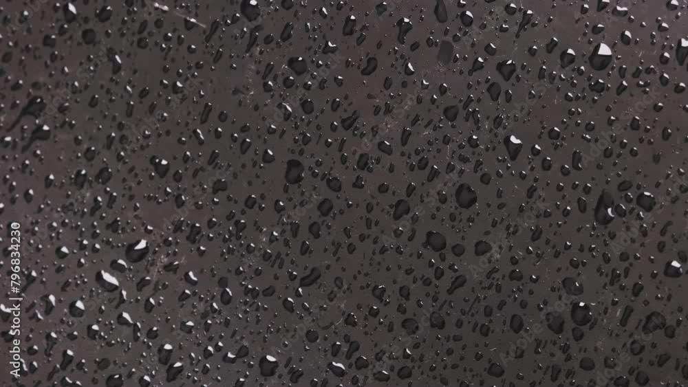 rain drops on black car bonnet surface, closeup with slow motion rain drops on black car bonnet surface, closeup with slow motion