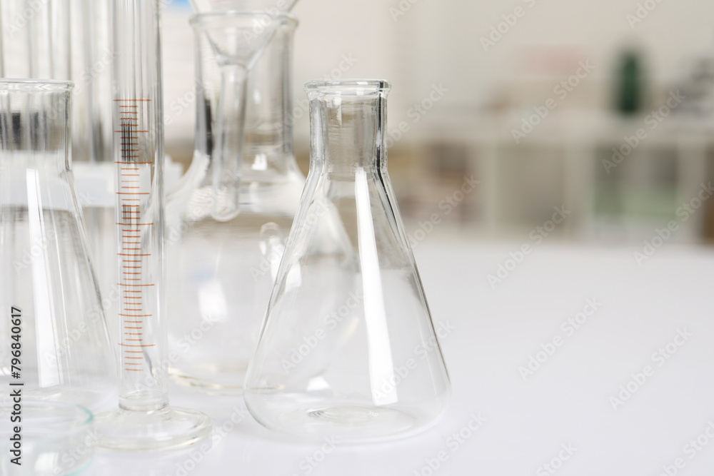 Laboratory analysis. Different glassware on white table indoors, closeup. Space for text Laboratory analysis. Different glassware on white table indoors, closeup. Space for text