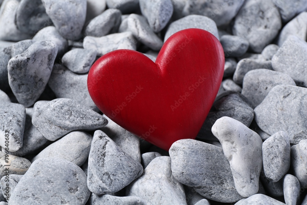 Obraz premium Red decorative heart on grey stones, closeup
