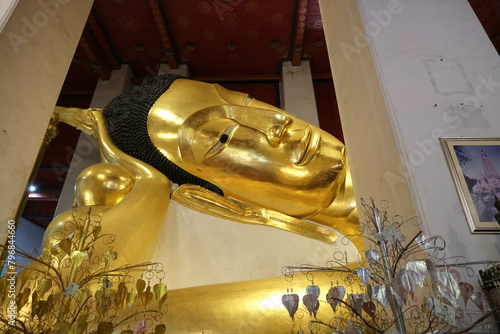 Face of Phra Non Chakkrasi at Wat Phra Non Chakkrasi Worawihan is gold reclining buddha big statue. © Warida.lnnl