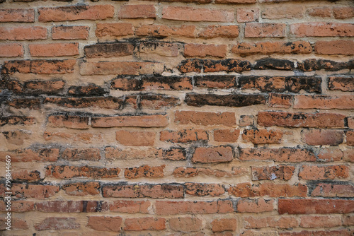 Antique wall of red old bricks in a row. Vintage bricks background. © Warida.lnnl
