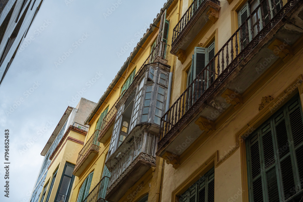 Malaga, Spain, view of the eastern and modern architectures on yellow residential building Malaga, Spain, view of the eastern and modern architectures on yellow residential building