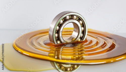 Power transmission bearing, in lubrication oil drip, background; transmission maintenance and industry business