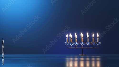 A beautiful blue background with a menorah in the center. The menorah is made of silver and has nine branches. photo