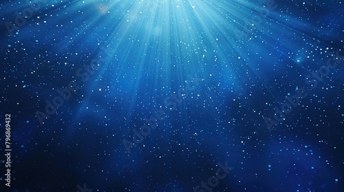 Rays of light with sparkling particles and soft bokeh effects of cosmic universe on dark blue background. Ideal for science, astronomy and creative projects