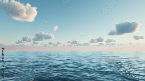 The image is a beautiful seascape. The ocean is calm and blue, and the sky is clear with a few white clouds.