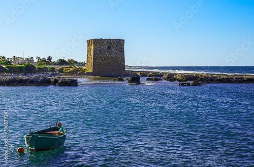 Watchtower, beautiful old tower in San Vito, Polignano a Mare, Bari, Puglia, Italy with blue sea, boat,, cactus, Mediterranean landscape
