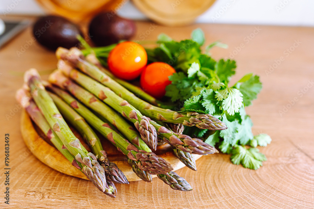 asparagus on wooden board on kitchen surface asparagus on wooden board on kitchen surface