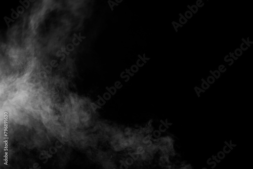 Isolated white fog on the black background, smoky effect for photos and artworks. Smoke and powder overlay on black background © PongstornPix