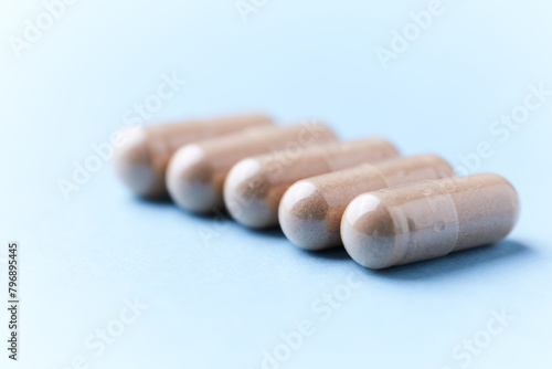 Ashwagandha (Withania somnifera) capsules. Bright paper background. Close up. 