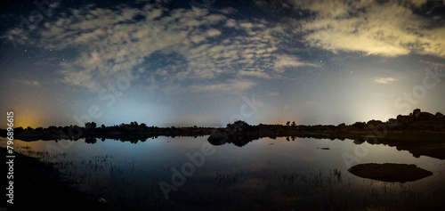 panoramic against the light of dawn in the lagoons of Los Barruecos with large granite masses photo