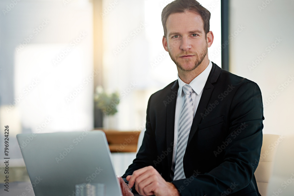 Portrait, serious and business man on laptop in office for corporate job in Switzerland. Face, confidence and professional entrepreneur on computer for research, project or agent in suit for work Portrait, serious and business man on laptop in office for corporate job in Switzerland. Face, confidence and professional entrepreneur on computer for research, project or agent in suit for work
