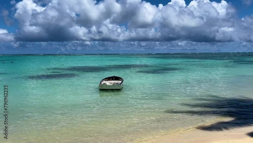 4K video, Tropical island, The shadow of palm trees falls on the sea. A fishing boat on the shore. mauiritius pereybere is a wonderful beach (ID: 796962235)