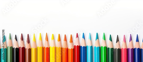 Colored pencils arrangement on white backdrop