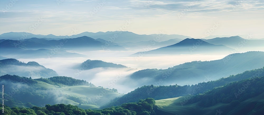 Mountains shrouded in mist and clouds in a valley