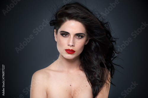 Face  woman and makeup or hair for beauty  bold color and eyeshadow on black background. Eyeliner  red lipstick and haircare shine with treatment in portrait  cosmetics and cosmetology for glamour