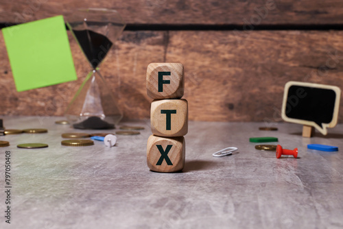 FTX . text on magnifier glass on white background. notepad on the desktop. photo