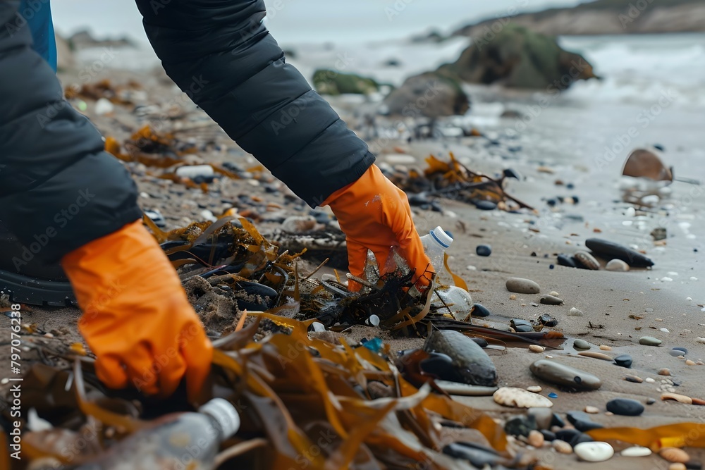 Anonymous person in orange gloves picking up trash on beach shore. Concept Environmental Conservation, Beach Cleanup, Volunteer Work, Cleanup Efforts, Anonymous Helper Anonymous person in orange gloves picking up trash on beach shore. Concept Environmental Conservation, Beach Cleanup, Volunteer Work, Cleanup Efforts, Anonymous Helper