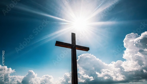 a cross in the sky with light and clouds