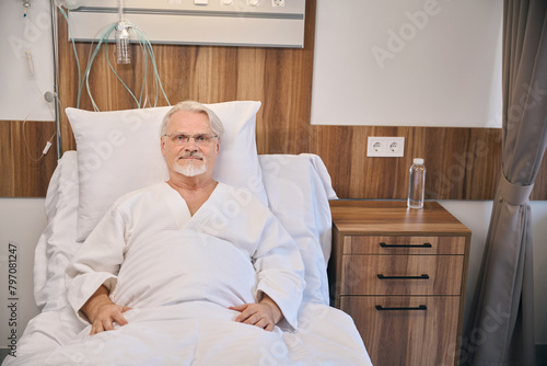 Hospitalized mature man lying in hospital bed