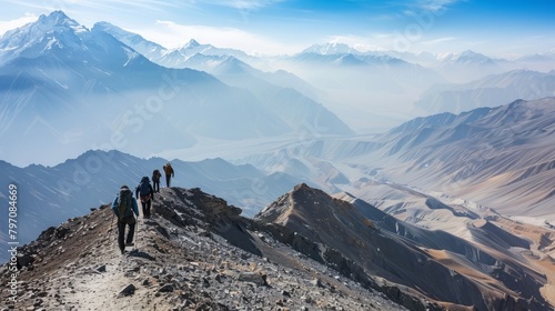 Mountaineers Climbing Rocky Slope, Expansive Mountain Vista, Clear Day © Ilia Nesolenyi