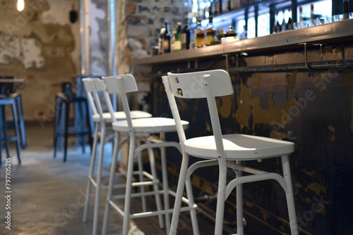 An industrial-style barstool chair with a white-painted metal frame