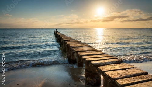 the sea and an old pier at the sunrise
