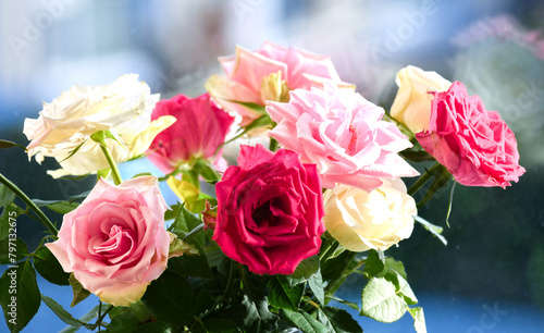 Bouquet of beautiful roses on the windowsill