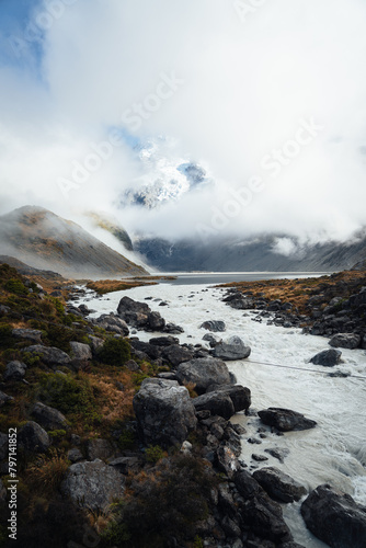 Alpine mountain landscape white peak with fog and river