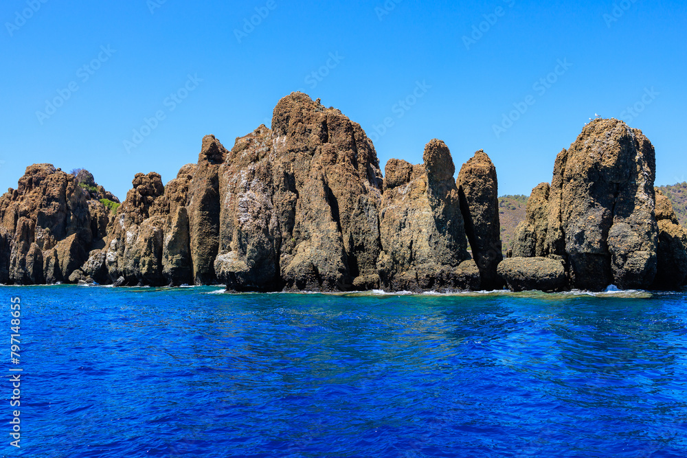 Rocky coast in the resort part of the Mediterranean or Aegean Sea. Background with selective focus and copy space Rocky coast in the resort part of the Mediterranean or Aegean Sea. Background with selective focus and copy space