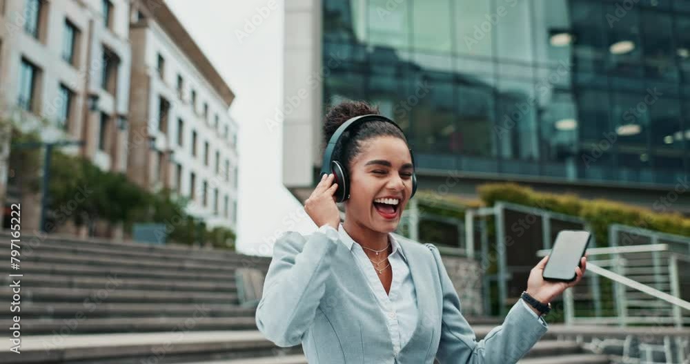 Businesswoman, phone or city to dance, wellbeing or happy streaming for work break outside office. Energy, excited and woman for headphone, fun and music on radio as stress relief in celebration Businesswoman, phone or city to dance, wellbeing or happy streaming for work break outside office. Energy, excited and woman for headphone, fun and music on radio as stress relief in celebration